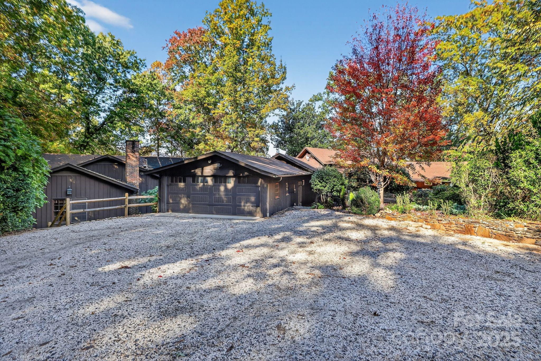 777 South River Road Tryon, NC 28782 - Photo 5 of 42 a house with a tree in front of it