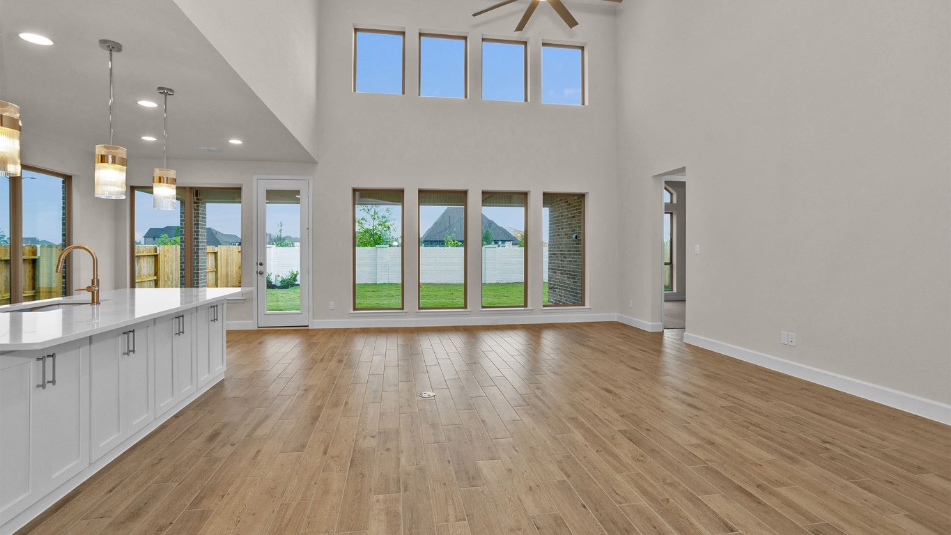 6539 Sparkling Citrus Street Manvel, TX 77578 - Photo 2 of 21 an empty room with wooden floor and windows