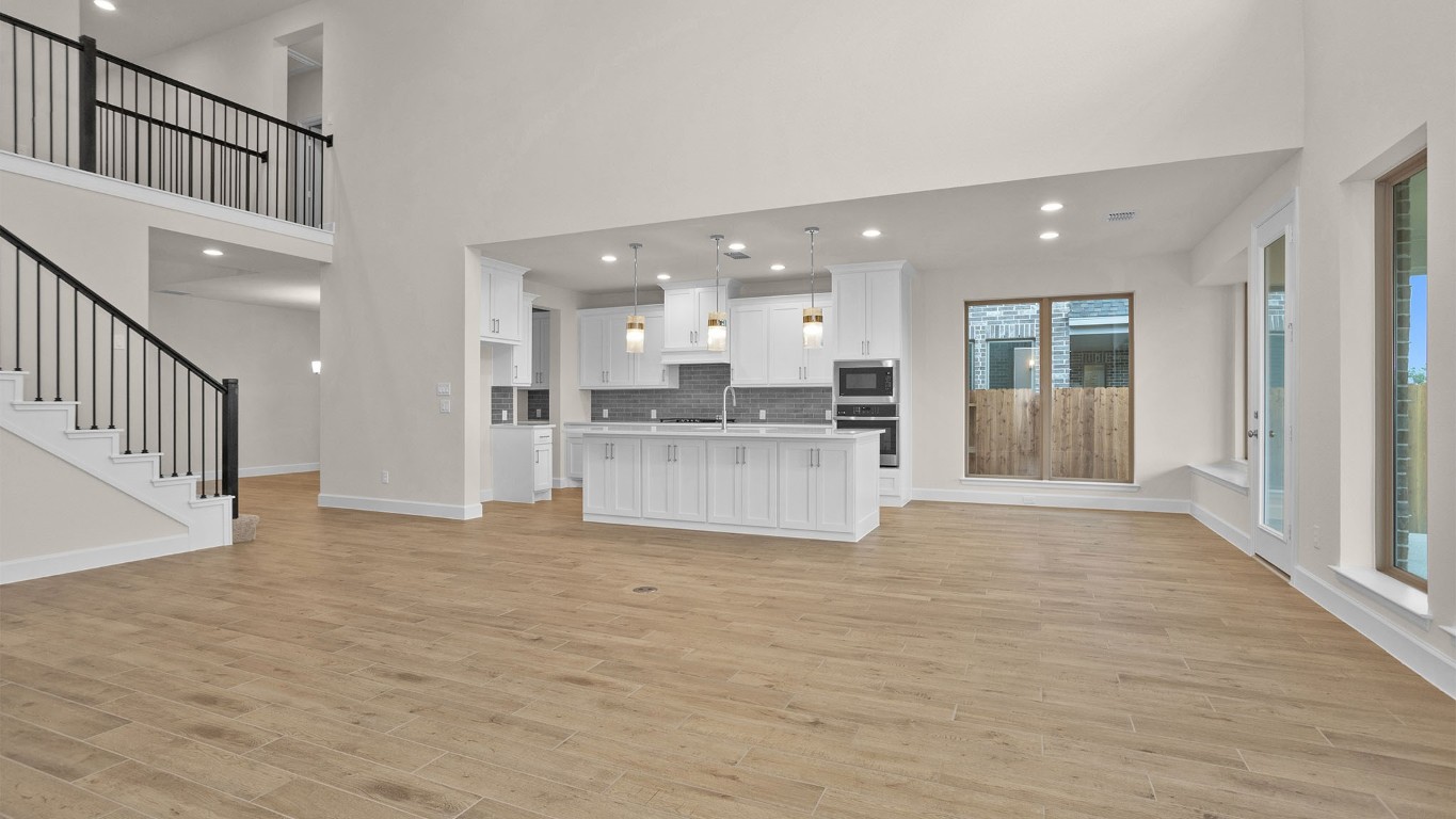 6539 Sparkling Citrus Street Manvel, TX 77578 - Photo 3 of 21 a view of kitchen with kitchen island wooden floor and refrigerator