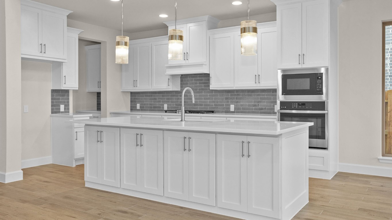 6539 Sparkling Citrus Street Manvel, TX 77578 - Photo 4 of 21 a kitchen with stainless steel appliances granite countertop a sink and cabinets