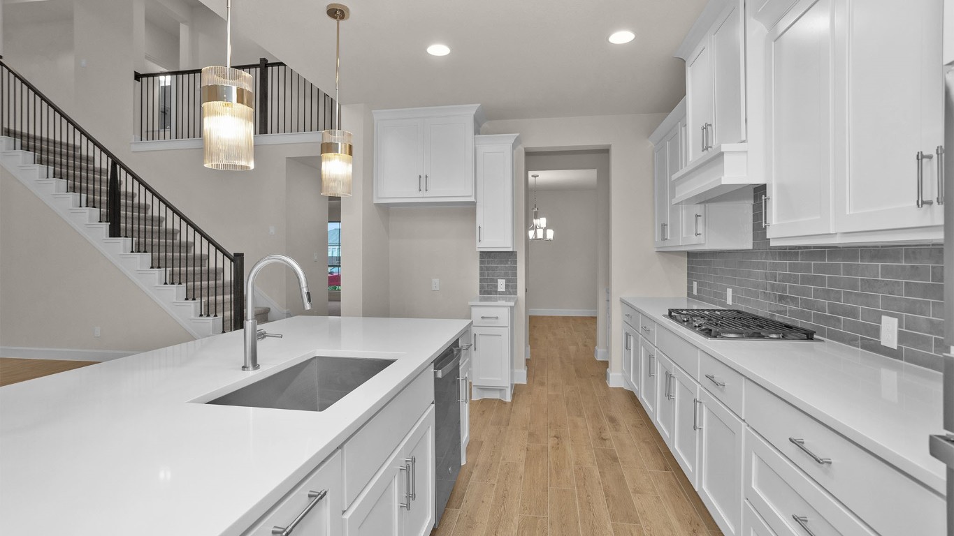 6539 Sparkling Citrus Street Manvel, TX 77578 - Photo 5 of 21 a kitchen with stainless steel appliances granite countertop a sink stove and cabinets
