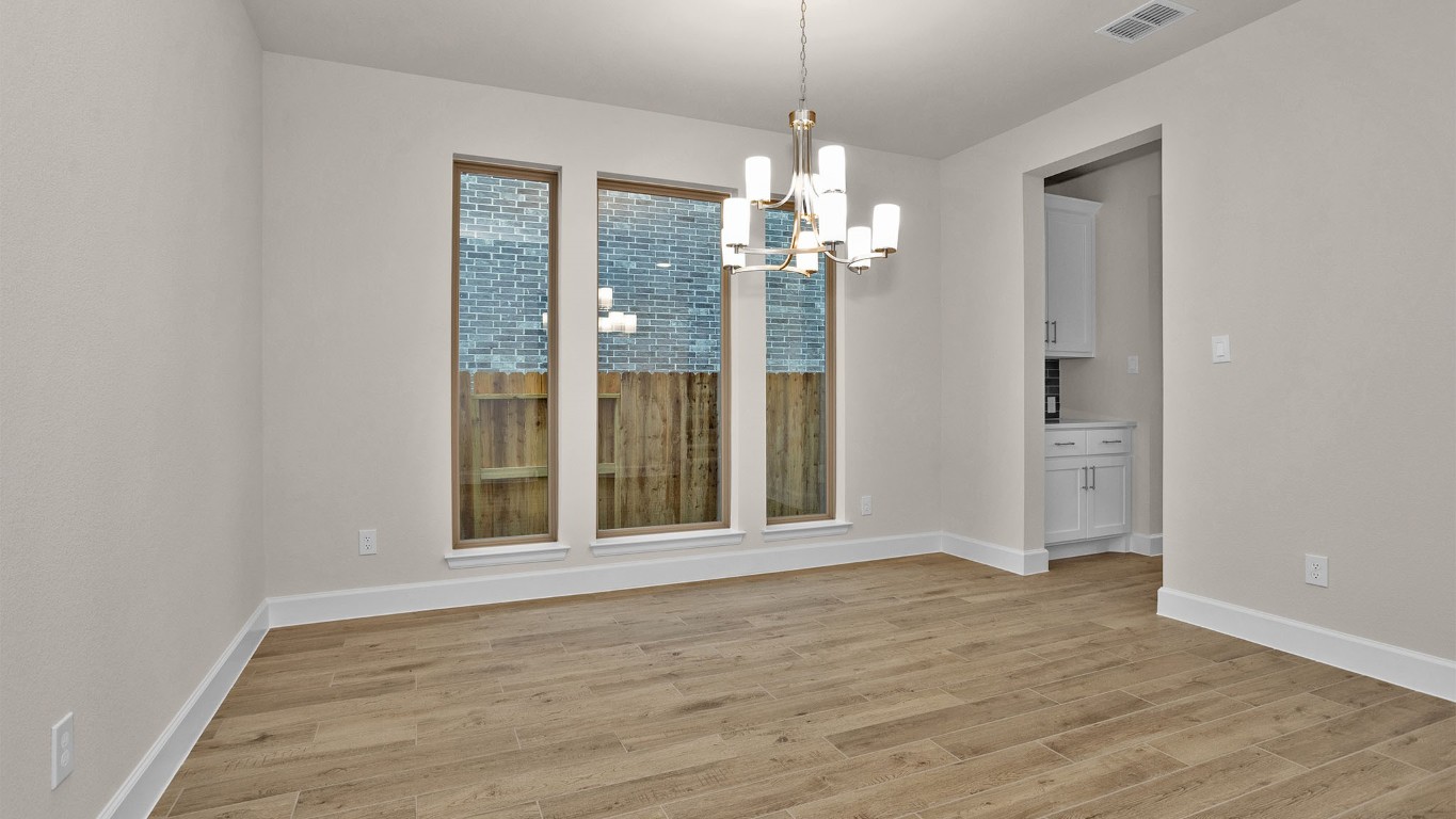 6539 Sparkling Citrus Street Manvel, TX 77578 - Photo 7 of 21 wooden floor in an empty room with a window