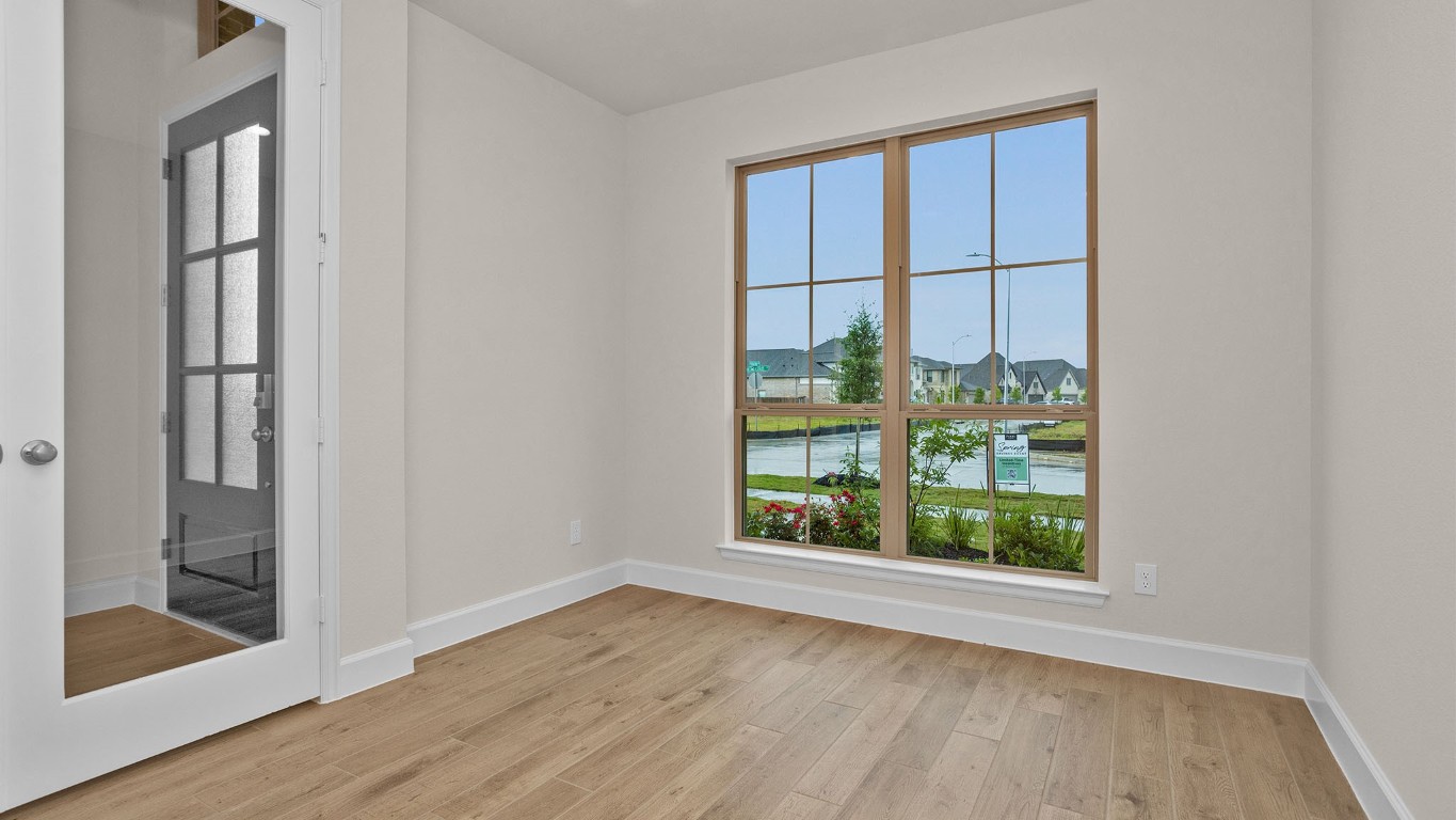 6539 Sparkling Citrus Street Manvel, TX 77578 - Photo 8 of 21 an empty room with wooden floor and windows