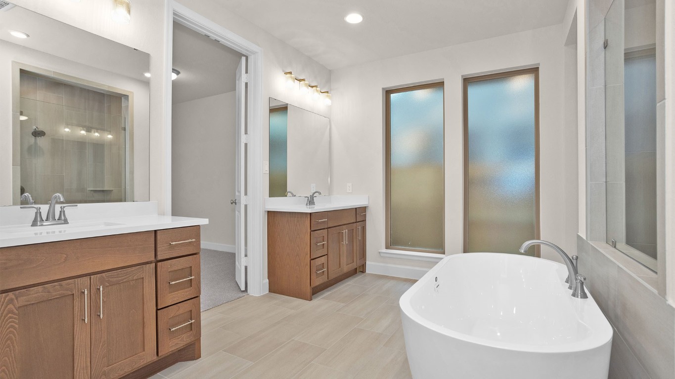 6539 Sparkling Citrus Street Manvel, TX 77578 - Photo 10 of 21 a spacious bathroom with a double vanity sink mirror and bathtub