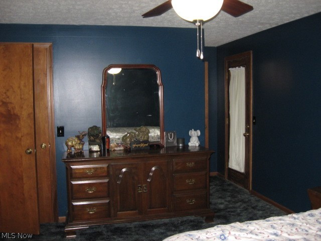 1166 Bass Circle Northwest Canton, OH 44708 - Photo 12 of 25 Bedroom with a textured ceiling, ceiling fan, and dark carpet