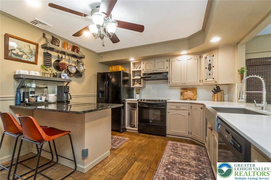 540 Briar Road Pen Argyl, PA 18072 - Photo 23 of 66 A well-lit kitchen with rich hardwood floors and ample counter space for culinary endeavors.