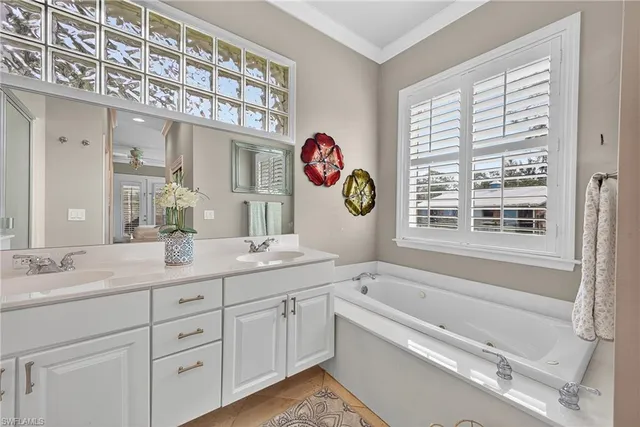 a kitchen with stainless steel appliances kitchen island granite countertop a stove top oven a refrigerator a sink and chairs