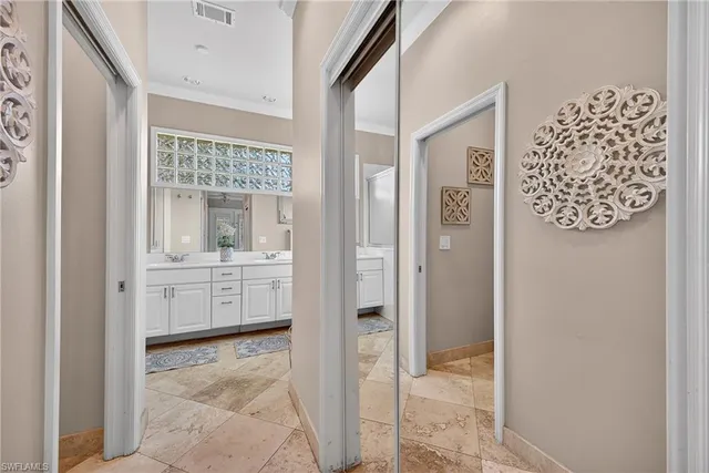 a large kitchen with cabinets chairs and stainless steel appliances