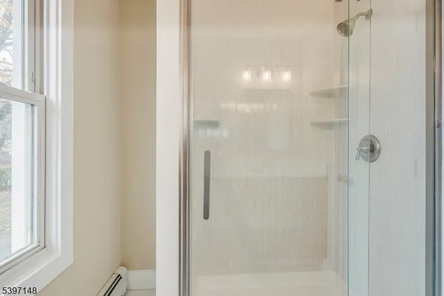 a bathroom with a glass shower door