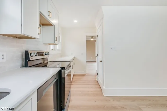 a kitchen with kitchen island a stove and a refrigerator