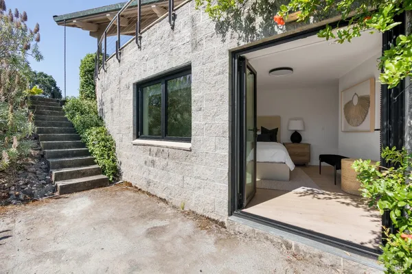 a view of house with backyard and potted plants