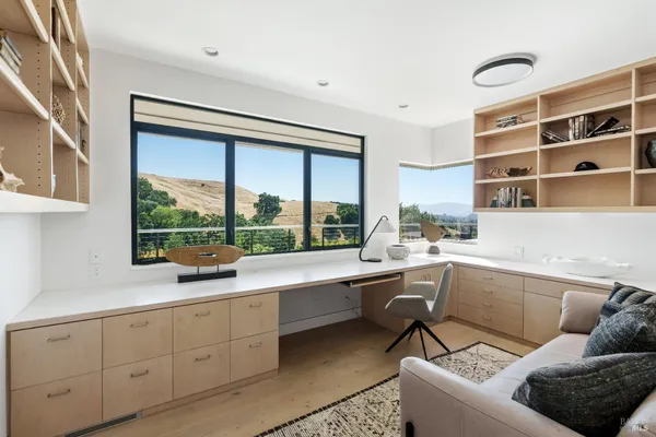 a living room with stainless steel furniture and a large window