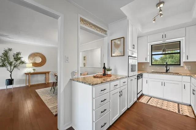 a open kitchen with stainless steel appliances granite countertop a stove and a sink
