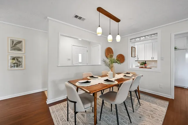 a view of a dining room with furniture and wooden floor
