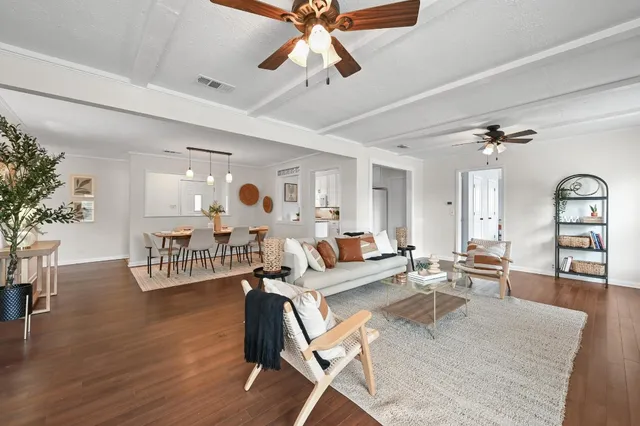 a living room with furniture and wooden floor