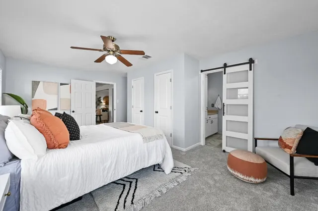 a bedroom with a bed and a chandelier