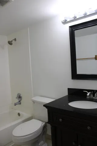a bathroom with a toilet a sink and bathtub