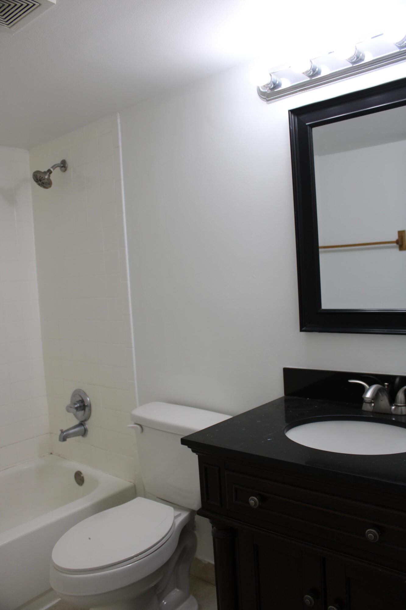 1006 Green Pine Boulevard, Unit H2 West Palm Beach, FL 33409 - Photo 8 of 12 a bathroom with a toilet a sink and bathtub