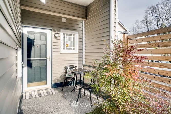 21624 9th Avenue Southeast, Unit D104 Bothell, WA 98021 - Photo 2 of 16 a view of a porch with chairs and a table