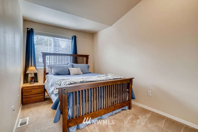 21624 9th Avenue Southeast, Unit D104 Bothell, WA 98021 - Photo 12 of 16 a bedroom with a bed and window