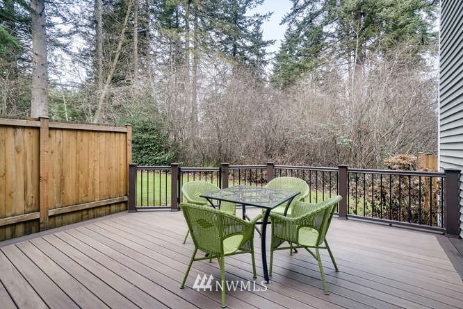 21624 9th Avenue Southeast, Unit D104 Bothell, WA 98021 - Photo 14 of 16 a view of balcony with wooden floor and bench