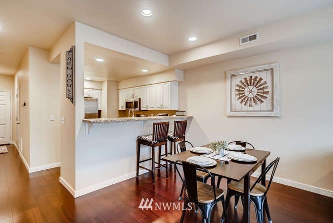 21624 9th Avenue Southeast, Unit D104 Bothell, WA 98021 - Photo 6 of 16 a view of a dining room with furniture and wooden floor