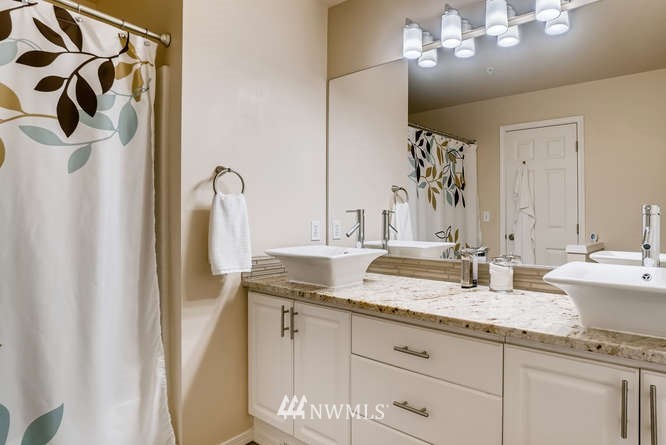 21624 9th Avenue Southeast, Unit D104 Bothell, WA 98021 - Photo 10 of 16 a bathroom with double sink and a mirror