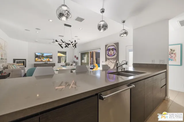 a view of a kitchen with a sink and chandelier