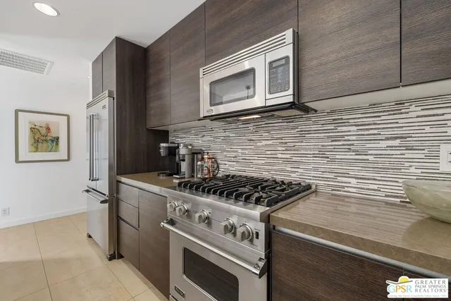 a kitchen with stainless steel appliances wooden cabinets and stove