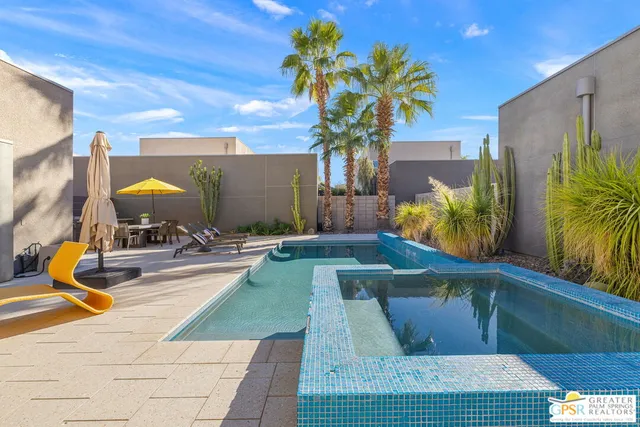 a view of a swimming pool with a lounge chair