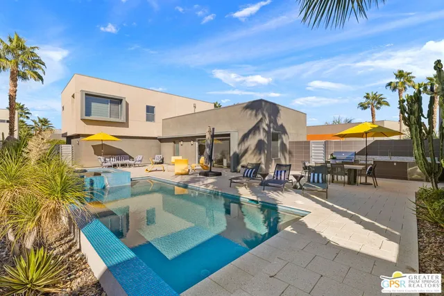 a view of a swimming pool with outdoor seating