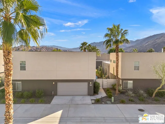 an aerial view of a house with palm tree