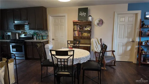 a dining room with furniture and wooden floor
