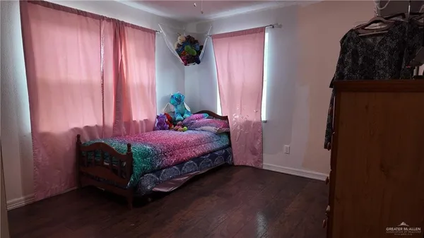 a spacious bedroom with a bed and a window