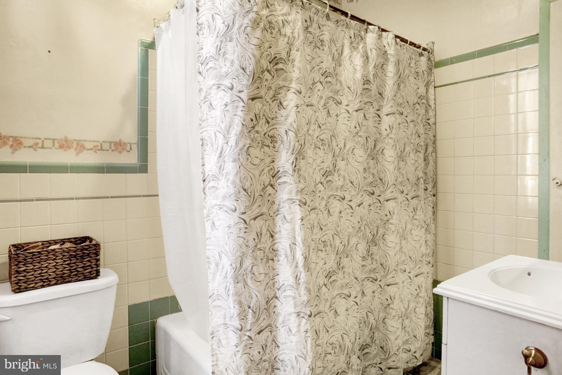 230 South 18th Street Reading, PA 19602 - Photo 14 of 24 a bathroom with a shower curtain and a sink