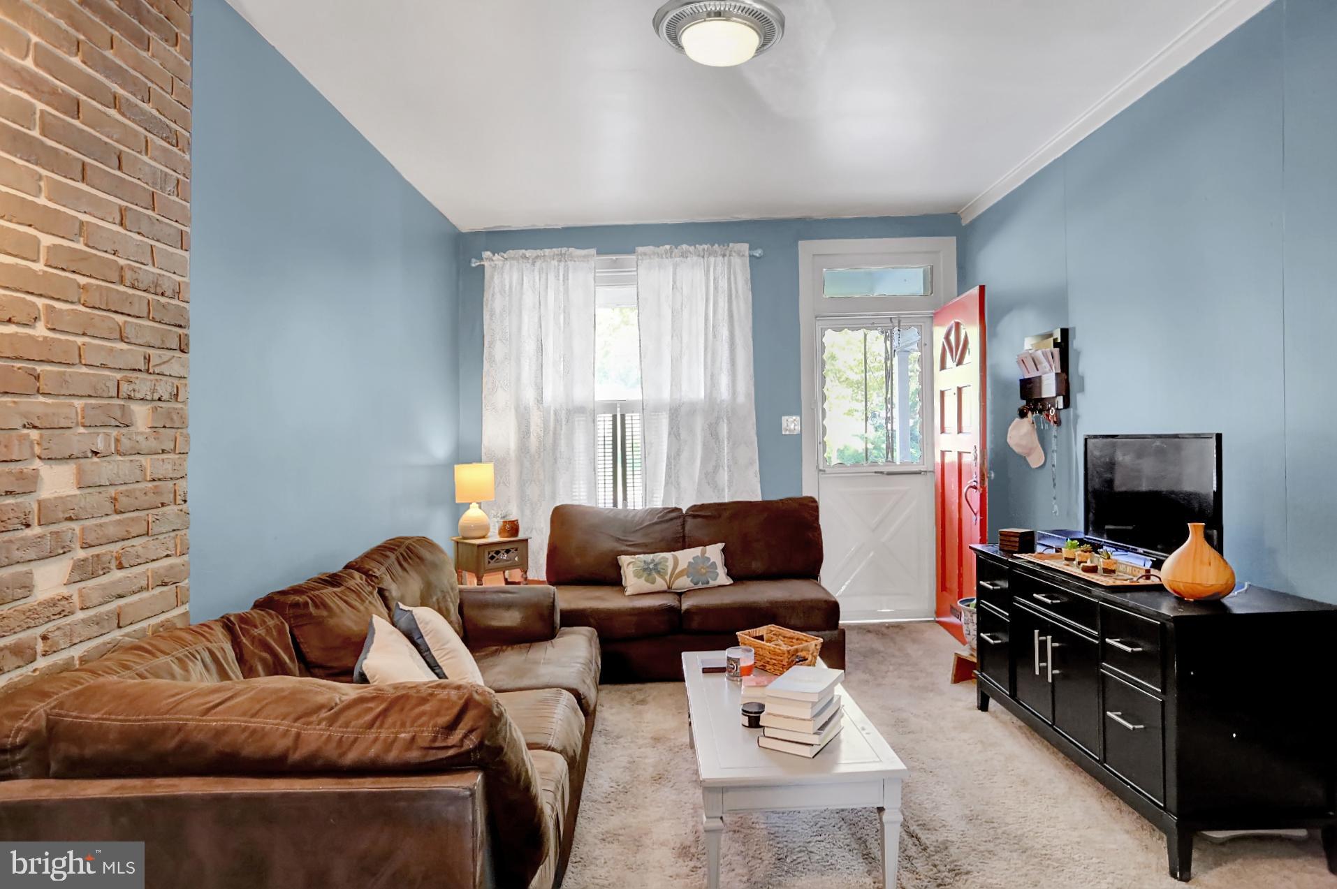 230 South 18th Street Reading, PA 19602 - Photo 5 of 24 a living room with furniture and a flat screen tv