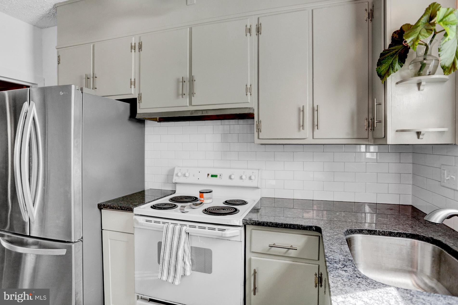 230 South 18th Street Reading, PA 19602 - Photo 9 of 24 a kitchen with stainless steel appliances granite countertop a refrigerator sink and stove