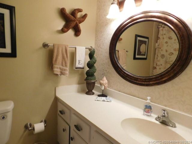 2273 Northwest 22nd Avenue, Unit 104 Stuart, FL 34994 - Photo 14 of 17 a bathroom with a sink and a mirror