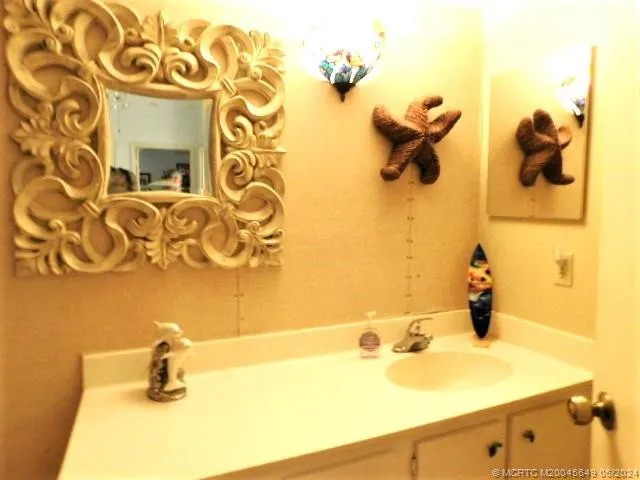 a bathroom with a sink and mirror