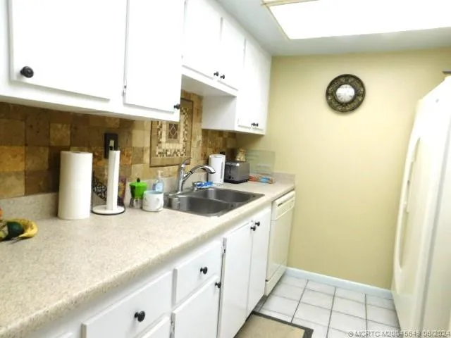 a kitchen with sink and cabinets