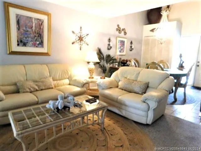 a living room with furniture a rug and a painting on the wall
