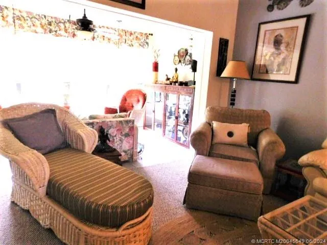 a living room with furniture and wall paintings