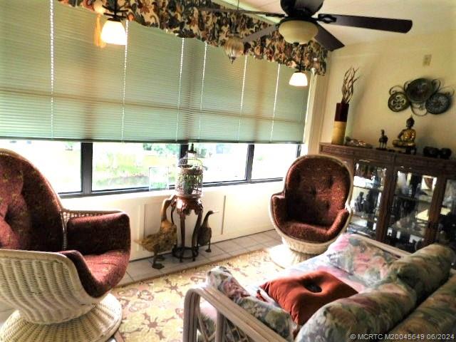 2273 Northwest 22nd Avenue, Unit 104 Stuart, FL 34994 - Photo 9 of 17 a living room with furniture and a chandelier