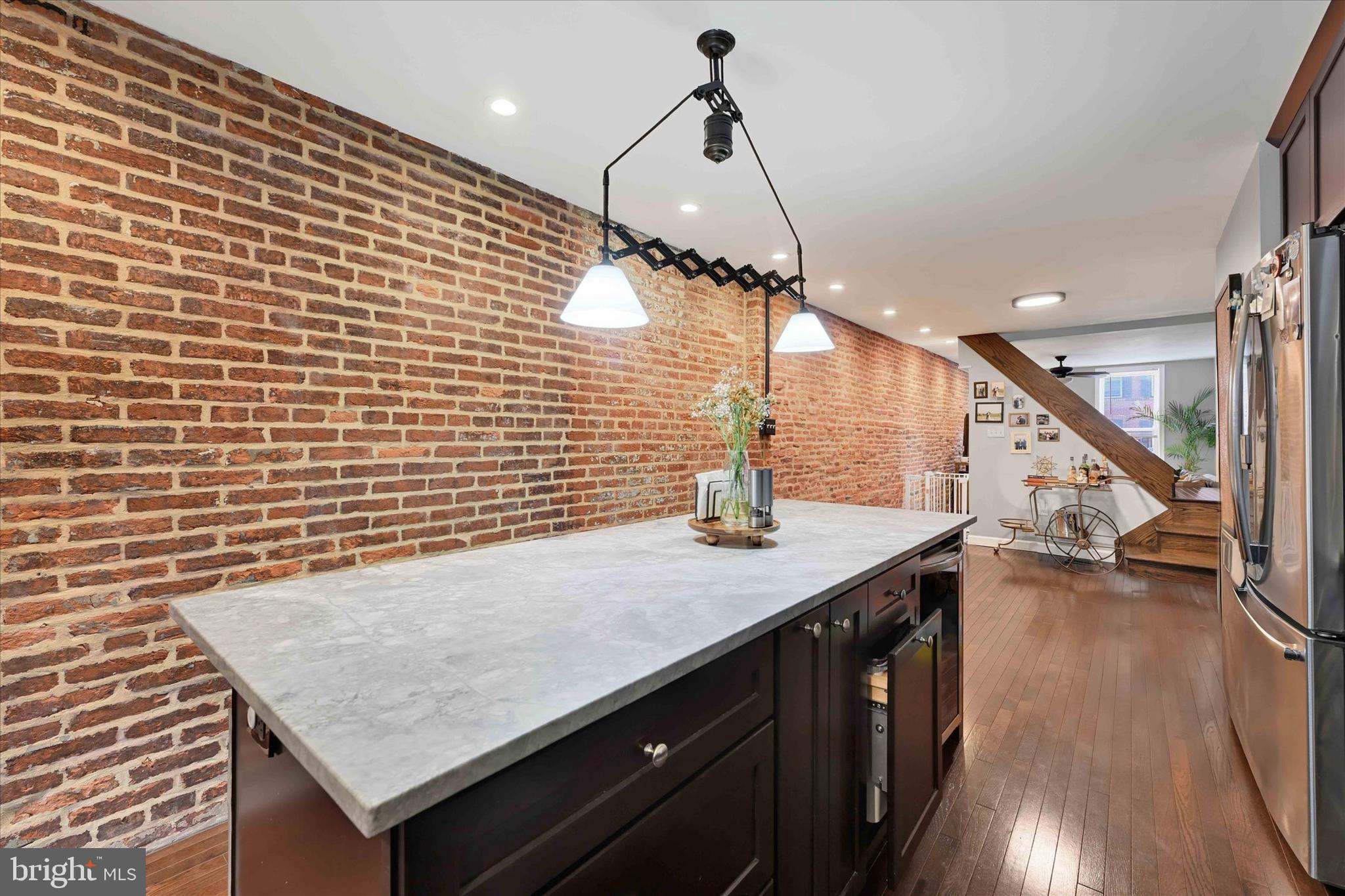 1436 Andre Street Baltimore, MD 21230 - Photo 11 of 35 a kitchen with a sink a counter space wooden floor and staircase