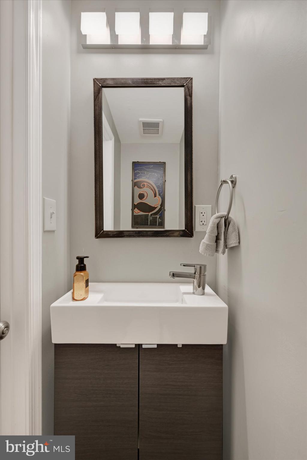 1436 Andre Street Baltimore, MD 21230 - Photo 14 of 35 a bathroom with a sink and a mirror