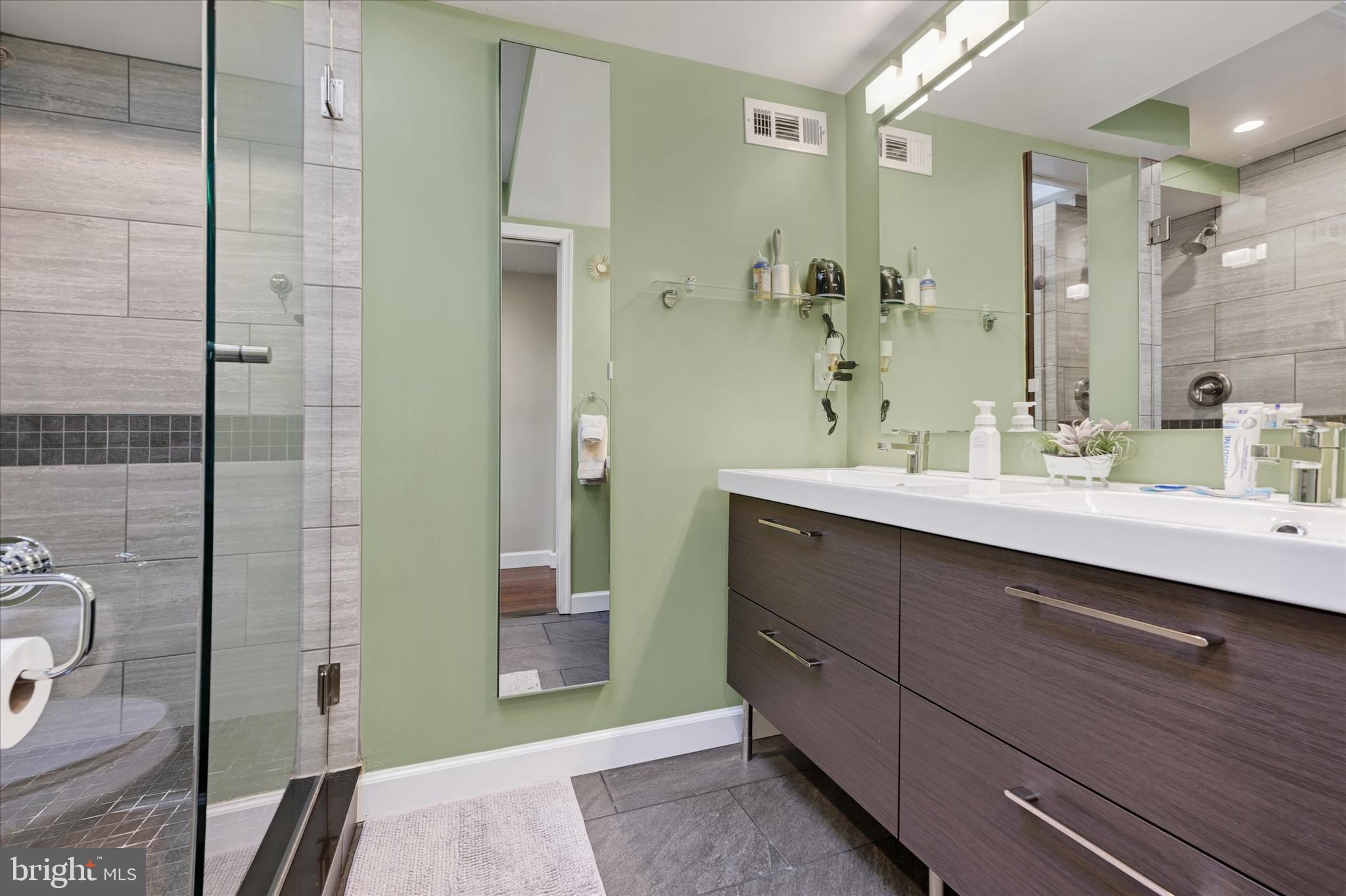 1436 Andre Street Baltimore, MD 21230 - Photo 17 of 35 a bathroom with a double vanity sink a toilet and shower