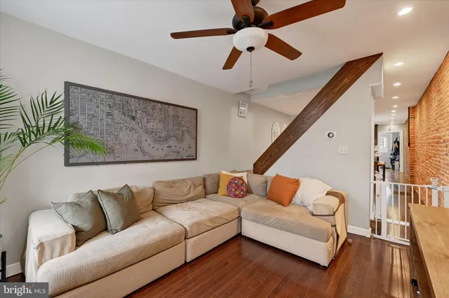 a living room with furniture and wooden floor