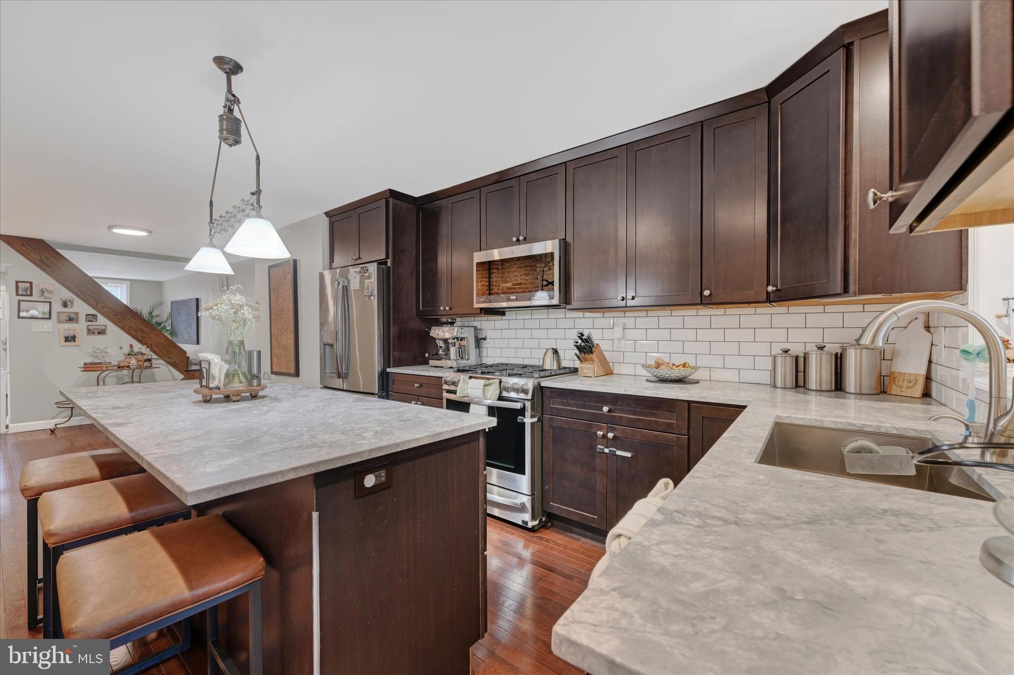 1436 Andre Street Baltimore, MD 21230 - Photo 10 of 35 a kitchen with a stove a sink a center island and cabinets