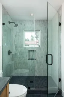 a bathroom with a shower toilet and sink