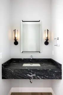 a bathroom with a sink and mirror
